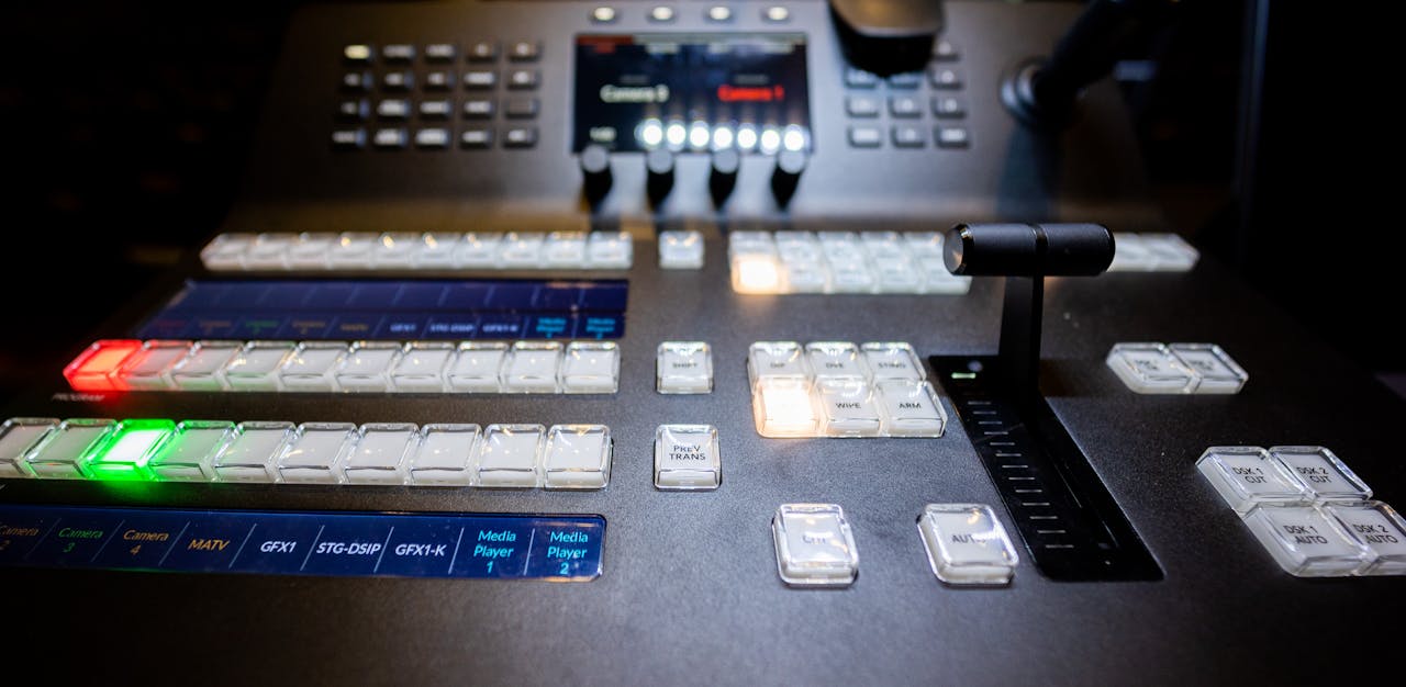 From above of contemporary professional audio mixer controller with buttons and switches in modern studio
